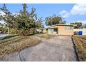 House with a large yard and a long driveway at 415 Country Club Dr, Oldsmar, FL 34677
