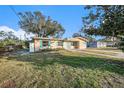 Single story home with a landscaped lawn at 415 Country Club Dr, Oldsmar, FL 34677