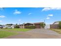 Ranch style home with a spacious lawn and driveway at 5147 Perennial Dr, Holiday, FL 34690
