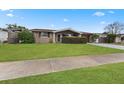 House exterior showcasing a neat lawn and a driveway at 5147 Perennial Dr, Holiday, FL 34690
