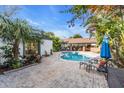 Relaxing poolside patio with lounge chairs and brick pavers at 6095 2Nd S Ave, St Petersburg, FL 33707