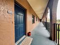 Condo building exterior showing hallway with dark blue front door and arched entryway at 6100 Gulfport S Blvd # 214, Gulfport, FL 33707