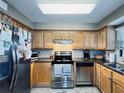 Well-equipped kitchen featuring light wood cabinets, granite counters, and stainless steel appliances at 6100 Gulfport S Blvd # 214, Gulfport, FL 33707