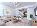 Spacious living room with a comfortable sofa and access to the dining area at 6781 121St Ave # F, Largo, FL 33773