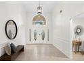 Bright foyer features high ceilings, neutral walls, tiled floor, and stylish décor at 8701 Ballantrae Way, Tampa, FL 33647