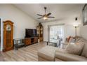 Living room with L-shaped sofa, hardwood floors, and plenty of natural light at 1616 Bondurant Way, Brandon, FL 33511