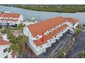 Aerial view of condo complex near waterway, highlighting subject property at 19201 Vista Ln # C8, Indian Shores, FL 33785