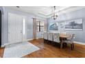 Formal dining room featuring hardwood floors and a rustic wooden table at 20000 Outpost Pt Dr, Tampa, FL 33647