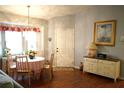 Bright dining area with a table, chairs, and hardwood floors at 2320 Marksmen Ct # 205, Sun City Center, FL 33573