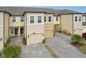 Townhome community featuring attached garages and paved driveways at 29857 Southwell Ln, Wesley Chapel, FL 33543