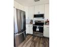 Stainless steel appliances and white shaker cabinets in this updated kitchen at 3628 Dellefield St, New Port Richey, FL 34655