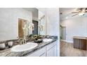 Double vanity bathroom with granite countertop and modern fixtures at 4318 Pullet Ct, Lakewood Ranch, FL 34211