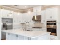 Spacious kitchen with white cabinets, stainless steel appliances, and a large island at 5531 Orsello St, Palmetto, FL 34221