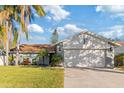 Well-maintained house with a spacious driveway and lush landscaping at 6709 Ranger Dr, Tampa, FL 33615