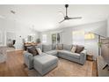 Spacious living room with L-shaped sectional sofa and hardwood floors at 7001 Interbay Blvd # 313, Tampa, FL 33616