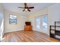 Living room with wood floors, ceiling fan and french doors at 9650 Starline Dr, Dade City, FL 33525