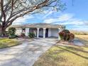Single story home with covered entry and side yard at 1009 Harefield Cir # 47, Sun City Center, FL 33573