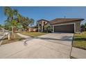 House exterior with a driveway and landscaping at 10126 Londonshire Ln, Tampa, FL 33647