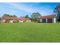 Spacious backyard with detached garage and large grassy area at 10813 Dixon Dr, Riverview, FL 33579