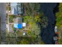 Aerial view of a house near the waterfront with lush landscaping at 1214 E Park Cir, Tampa, FL 33604