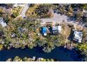 Aerial view showing home's location on riverfront lot with lush landscaping at 1214 E Park Cir, Tampa, FL 33604