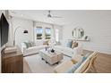 Open living room with shiplap wall and modern furniture at 2034 Amelia Bay Pl, Valrico, FL 33596