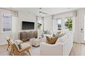 Bright living room with white sofa and wood floors at 2034 Amelia Bay Pl, Valrico, FL 33596