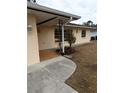 The home has a covered entryway and a tiled porch at 237 Orduna Dr, North Port, FL 34287
