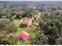 Aerial view of a home with pool and detached garage on a large lot at 249 Dogwood Trce, Tarpon Springs, FL 34688