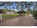 Metal garage with two garage doors sits on a grassy lot at 249 Dogwood Trce, Tarpon Springs, FL 34688