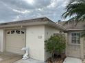 Tan single-car garage with gate and landscaping at 322 Boca Ciega Point N Blvd, St Petersburg, FL 33708