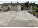Tan two-car garage, with driveway and landscaping at 322 Boca Ciega Point N Blvd, St Petersburg, FL 33708