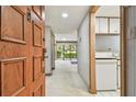 Residential entryway with wood door and view into the living area at 36750 Us Highway 19 N # 15118, Palm Harbor, FL 34684