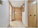 Interior hallway with wood doors and carpeted floor at 36750 Us Highway 19 N # 15118, Palm Harbor, FL 34684