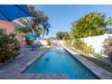 Relaxing rectangular pool surrounded by lush landscaping at 5611 8Th N Ave, St Petersburg, FL 33710