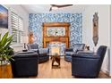 Relaxing sitting area with leather armchairs, a unique fireplace and hardwood floors at 5719 23Rd S Ave, Gulfport, FL 33707