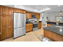 Modern kitchen with stainless steel appliances and granite countertops at 60 Morning Dove Pl, Oldsmar, FL 34677