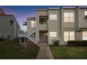 Condo building exterior at dusk with stairs and walkway at 6181 Bahia Del Mar Blvd # 209, St Petersburg, FL 33715
