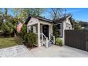 Renovated home with modern curb appeal, featuring a fresh coat of paint and updated landscaping at 7209 N Highland Ave, Tampa, FL 33604