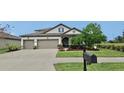 Two story house with three-car garage and nicely landscaped front yard at 12314 Bay Estuary Bnd, Riverview, FL 33579