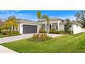 Contemporary home with gray garage door and attractive landscaping at 201 S Shade Ave, Sarasota, FL 34237