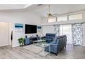 Living room with vaulted ceiling, hardwood floors, and view of pool at 2250 Rio De Janeiro Ave, Punta Gorda, FL 33983
