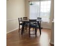 Dining area features a wood table with four chairs and hardwood flooring at 23917 Pow Wow Dr, Lutz, FL 33559