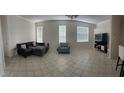 Spacious living room with tile floors and ample natural light at 23917 Pow Wow Dr, Lutz, FL 33559