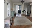 Bright and airy living room with hardwood floors and access to the backyard at 23917 Pow Wow Dr, Lutz, FL 33559