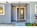 Dark brown front door with a glass oval window and sidelights at 2820 S Pines Dr # 125, Largo, FL 33771