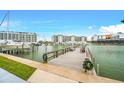 Wooden dock with seating area, offering scenic waterfront views at 320 Medallion Blvd # D, Madeira Beach, FL 33708