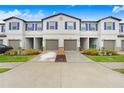 Modern townhouse with attractive landscaping and attached garages at 36401 Camp Fire Ter, Zephyrhills, FL 33541