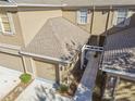Tan townhome building with attached garage and walkway at 4207 Key Thatch Dr, Tampa, FL 33610
