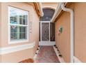 Front entry with decorative screen door and brick walkway at 5004 Sandy Brook Cir, Wimauma, FL 33598